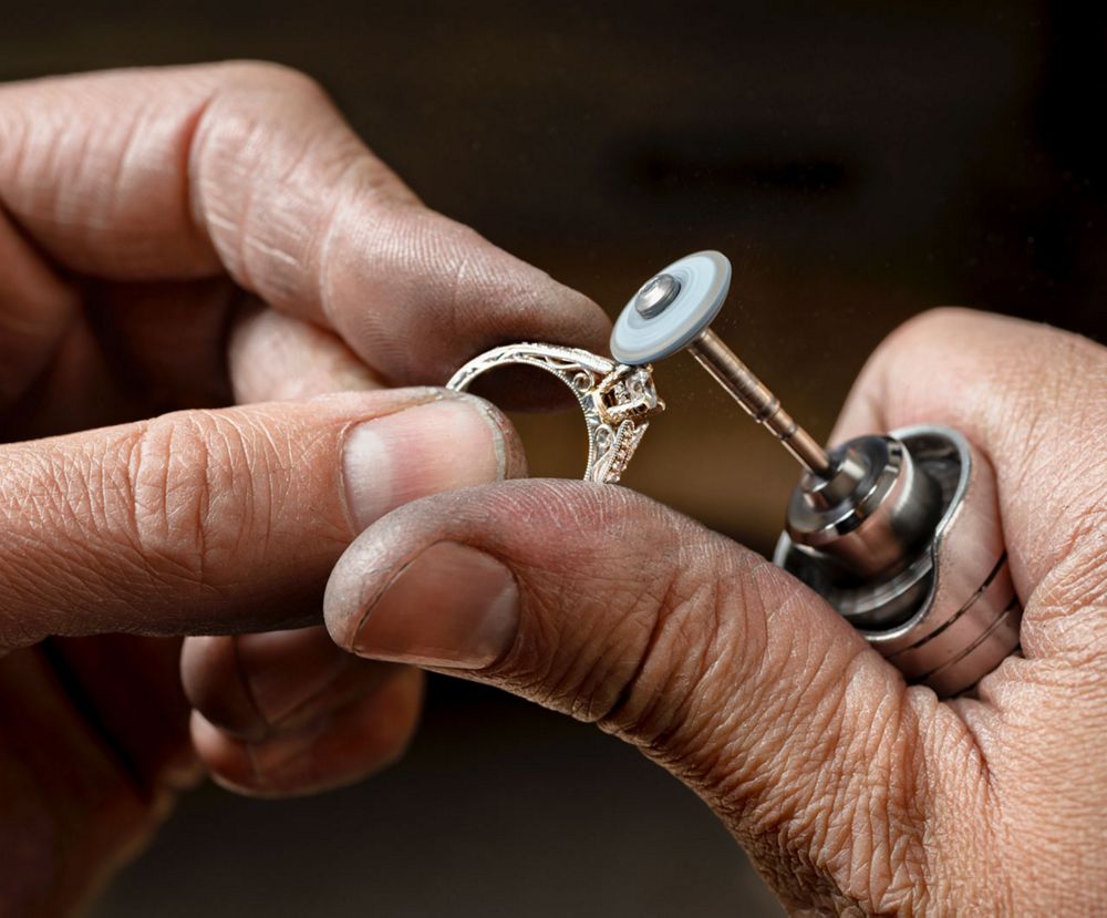A jeweler polishing a ring
