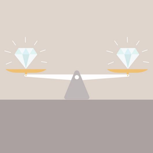 An illustration of two diamonds on a set of balancing scales