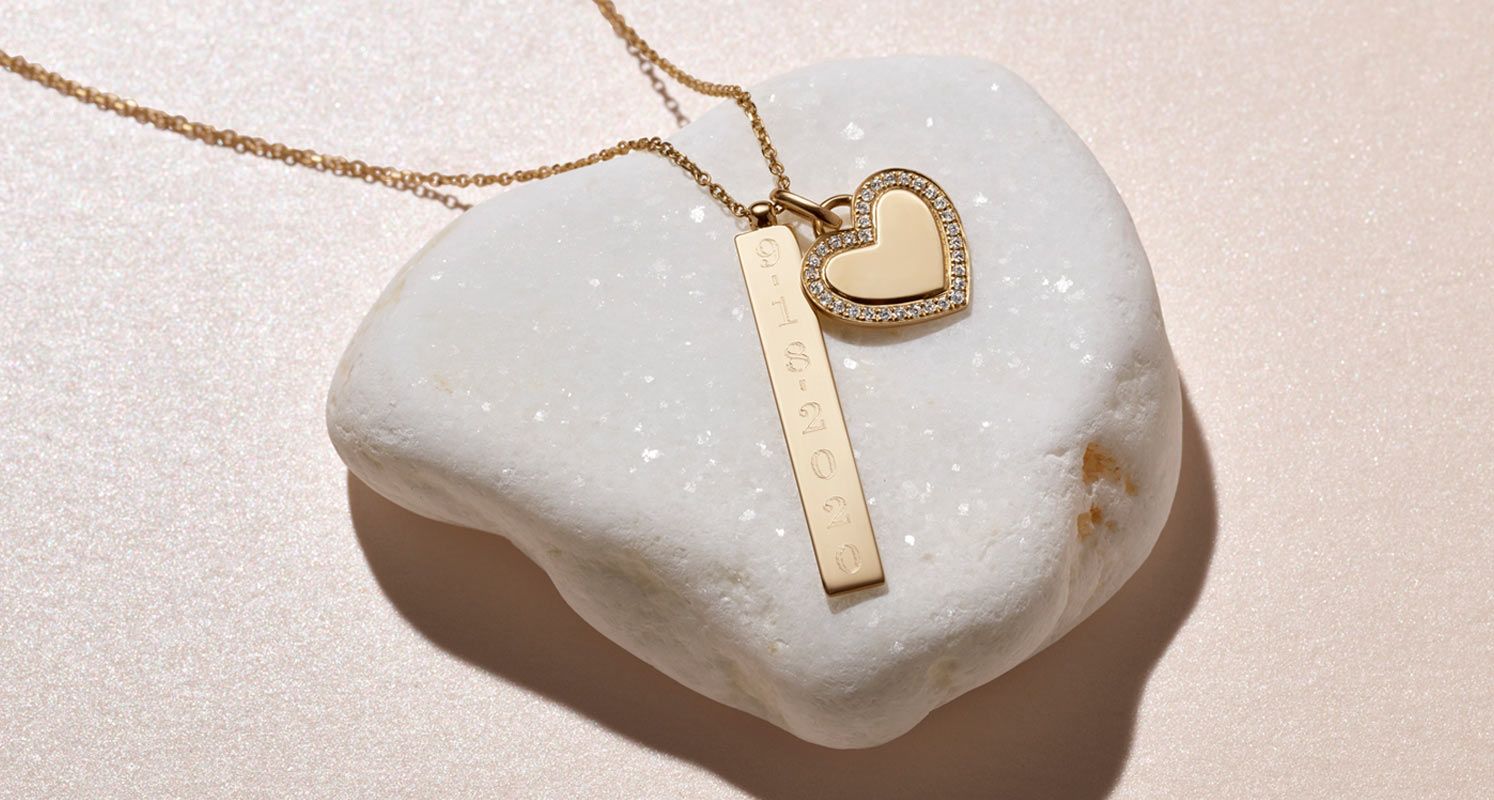 An engraved vertical pendant and heart pendant