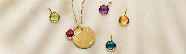 Mobile image of a collection of birthstone charms and an engraved disc charm