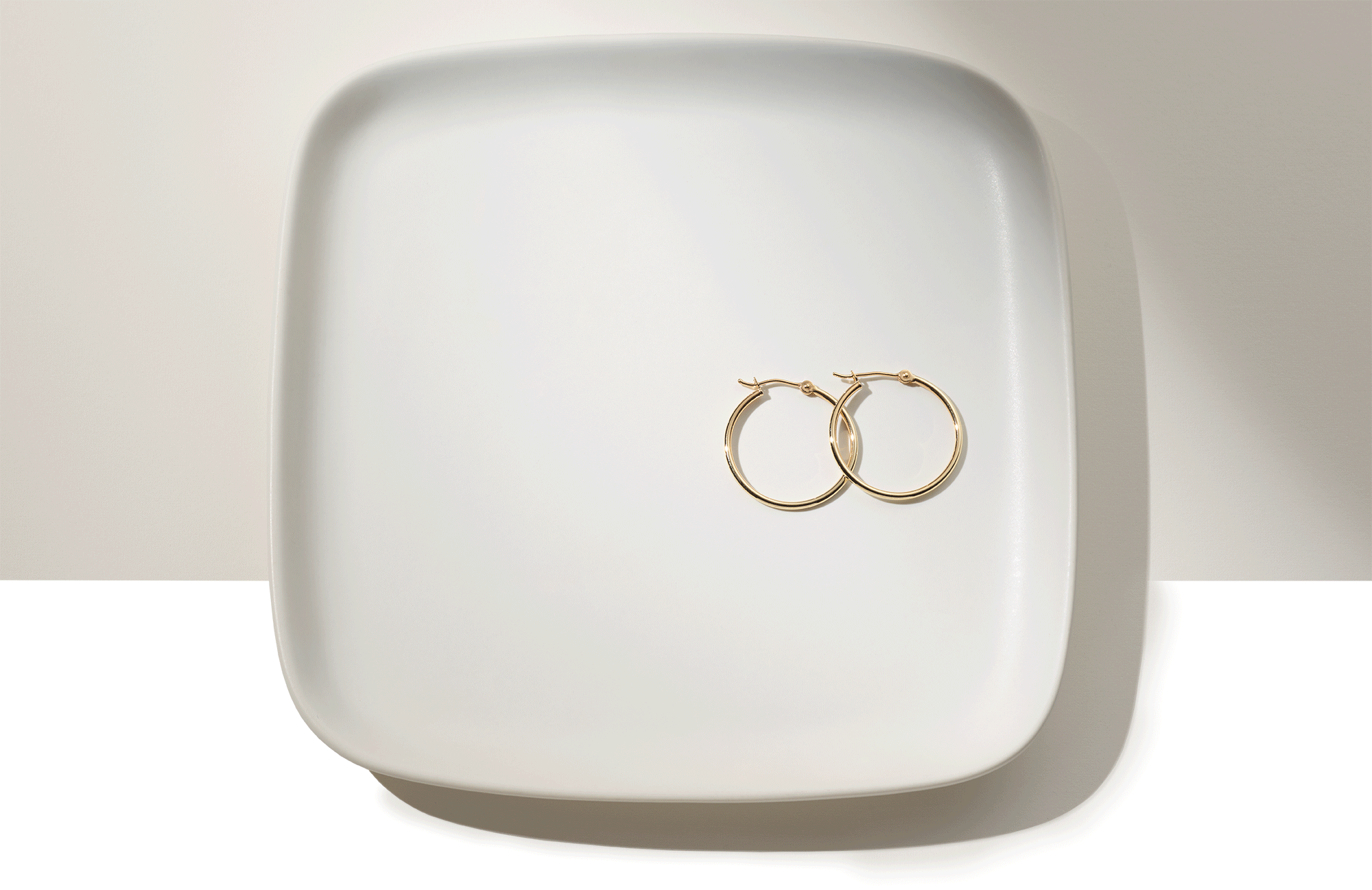 A gif of hoop earrings on a plate