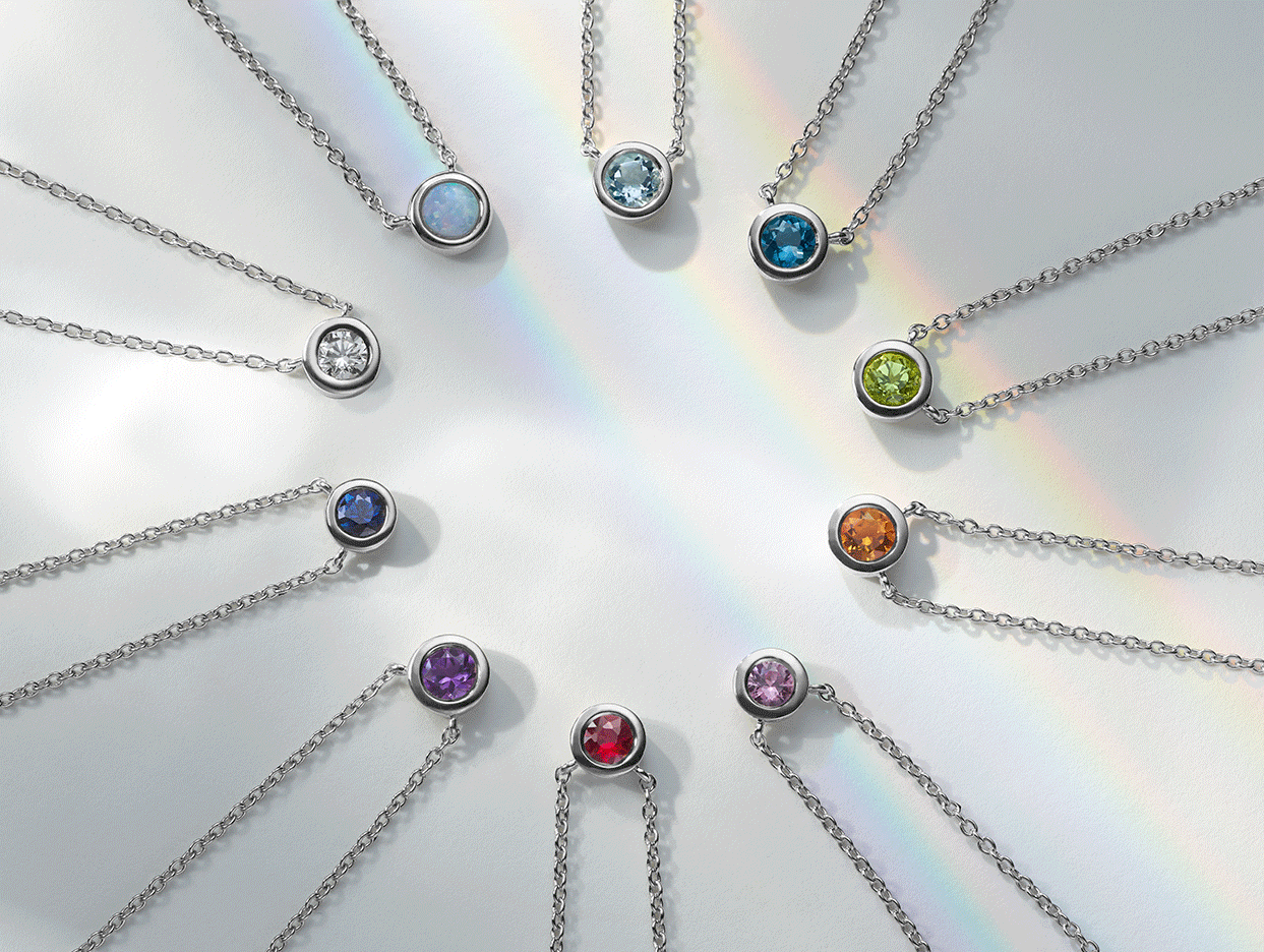 A gif of gemstone pendants changing into raw gemstones