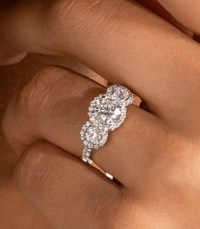 Up Close Three Stone Engagement Ring on Finger