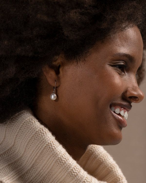 Woman Wearing a pair of pearl earrings