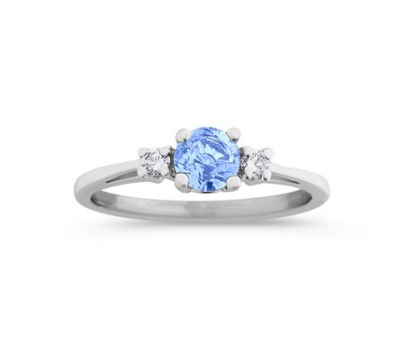 A round ice blue sapphire and diamond three-stone ring
