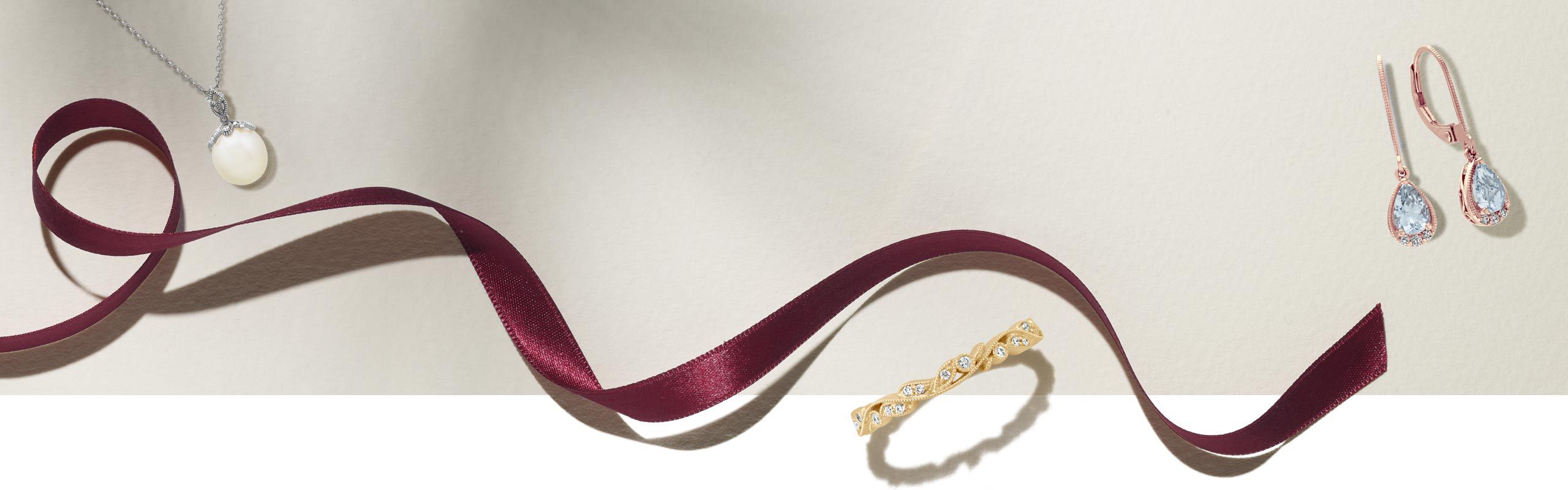 Image of holiday ribbon and vintage jewelry