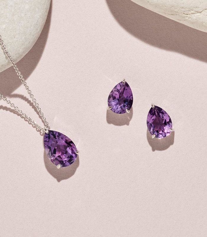 Mobile image of a pair of amethyst earrings and an amethyst solitaire pendant