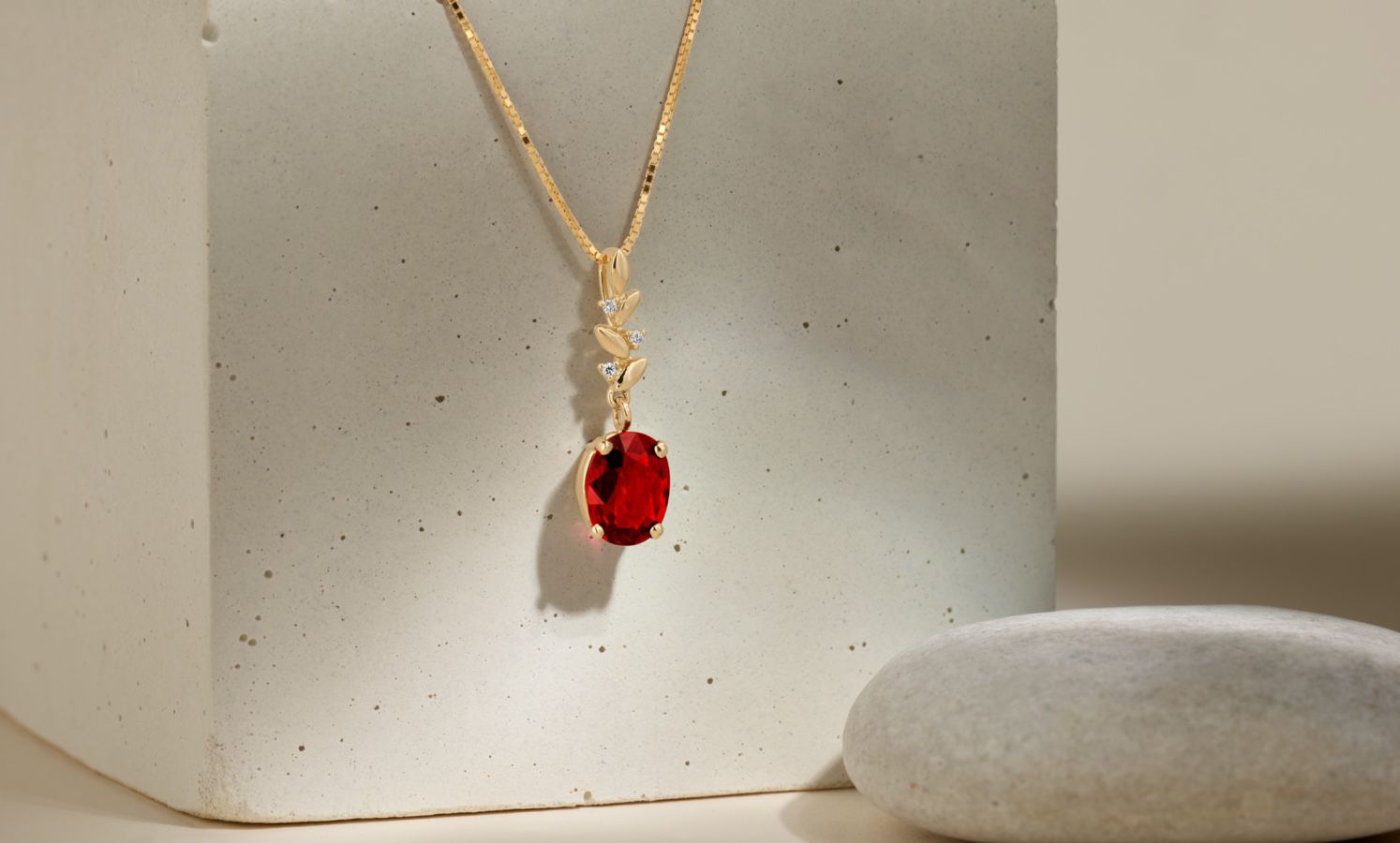 A gemstone and diamond pendant