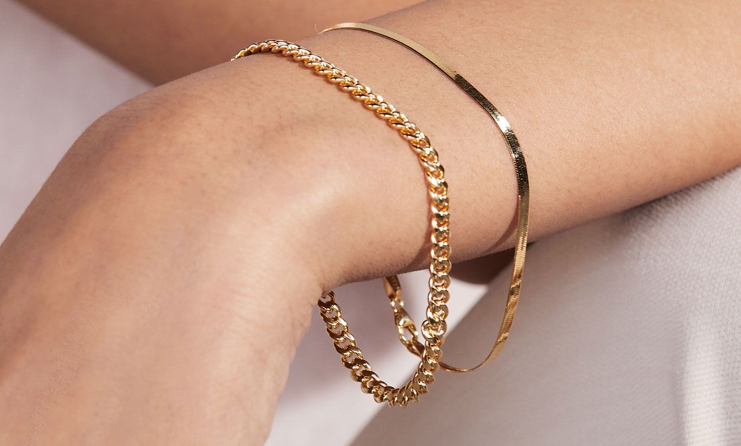 A woman wearing gold bracelets