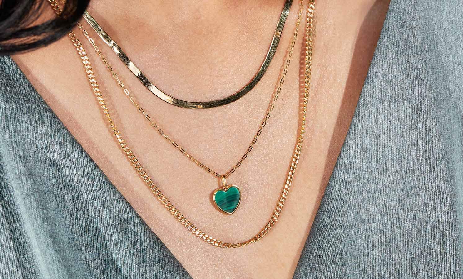 A woman wearing three layered necklaces