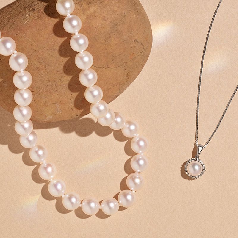 A pearl pendant and pearl strand necklace