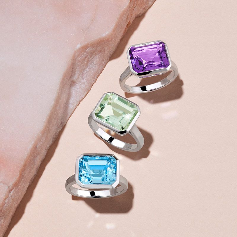 A collection of colored gemstone fashion rings