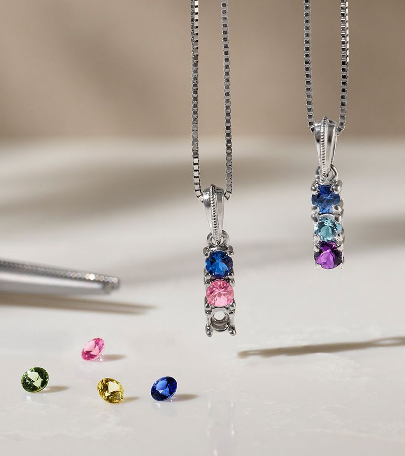 Two fashion pendants with three gemstones in each