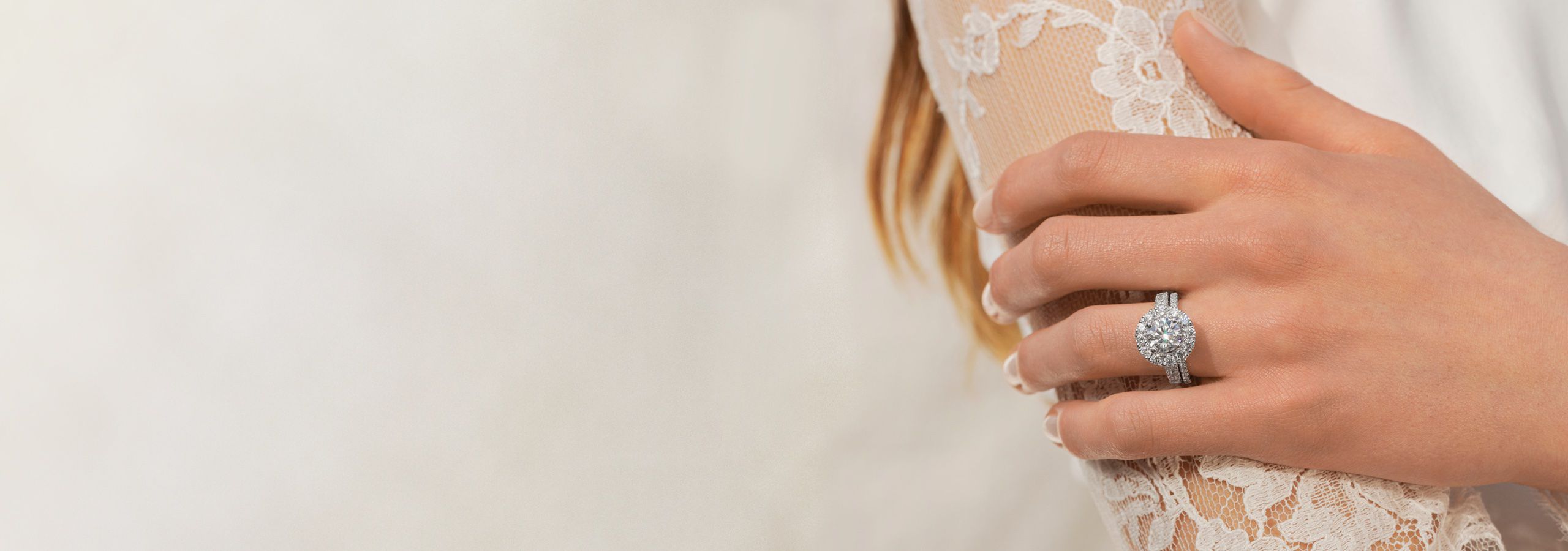 A woman wearing a diamond engagement ring and wedding band