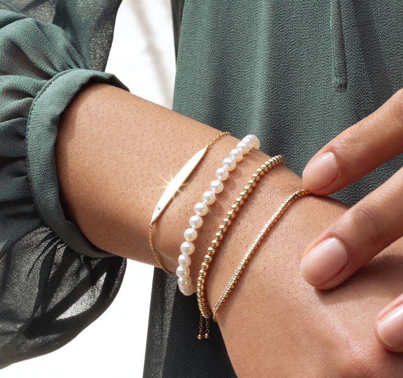 A woman wearing a collection of fashion bracelets