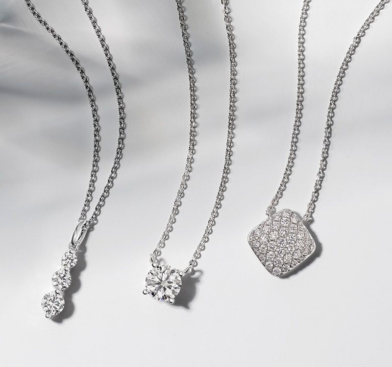 A collection of diamond fashion pendants