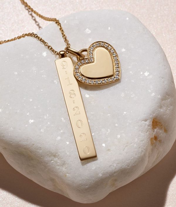 Mobile image of a heart shaped pendant and engraved gold bar pendant