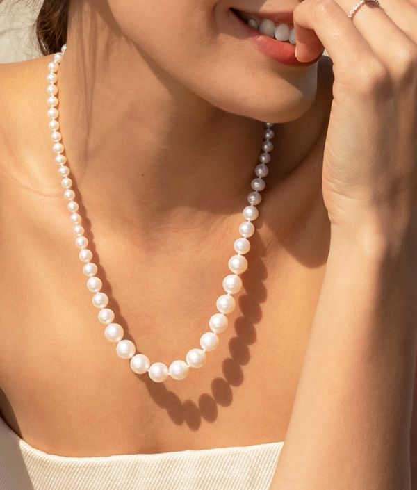 Mobile image of a woman wearing a pearl necklace