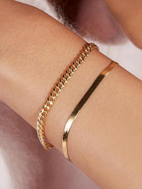 Mobile image of a woman wearing two fashion bracelets