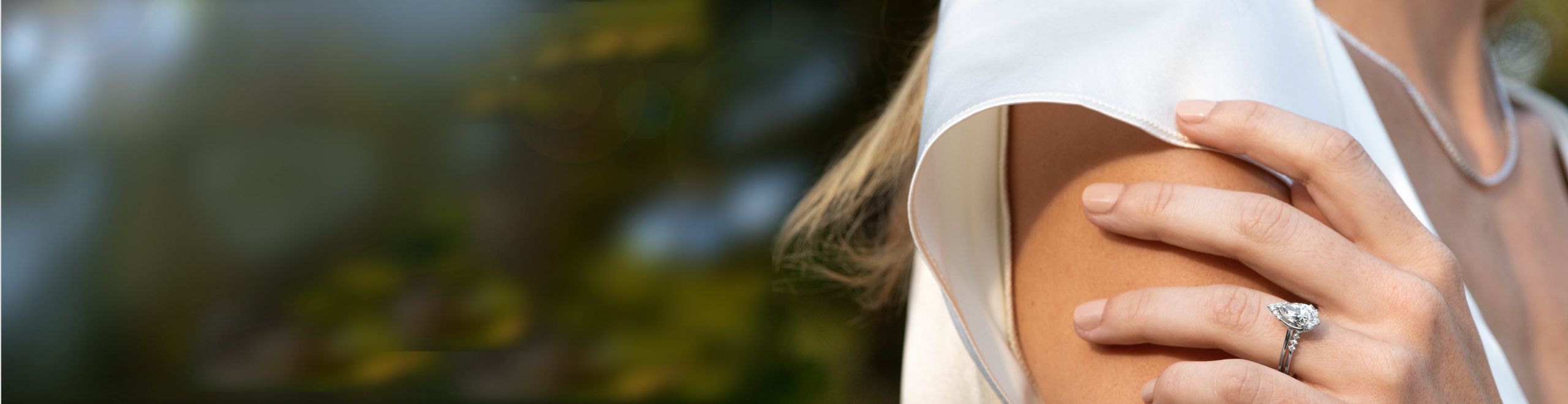 A woman wearing a diamond engagement ring and wedding band