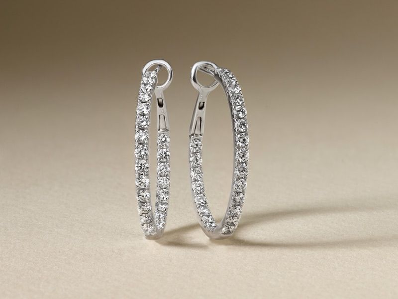 A pair of diamond and pearl earrings