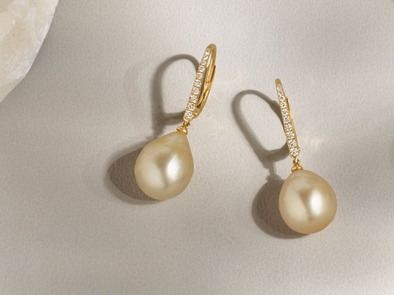 A pair of diamond and pearl earrings