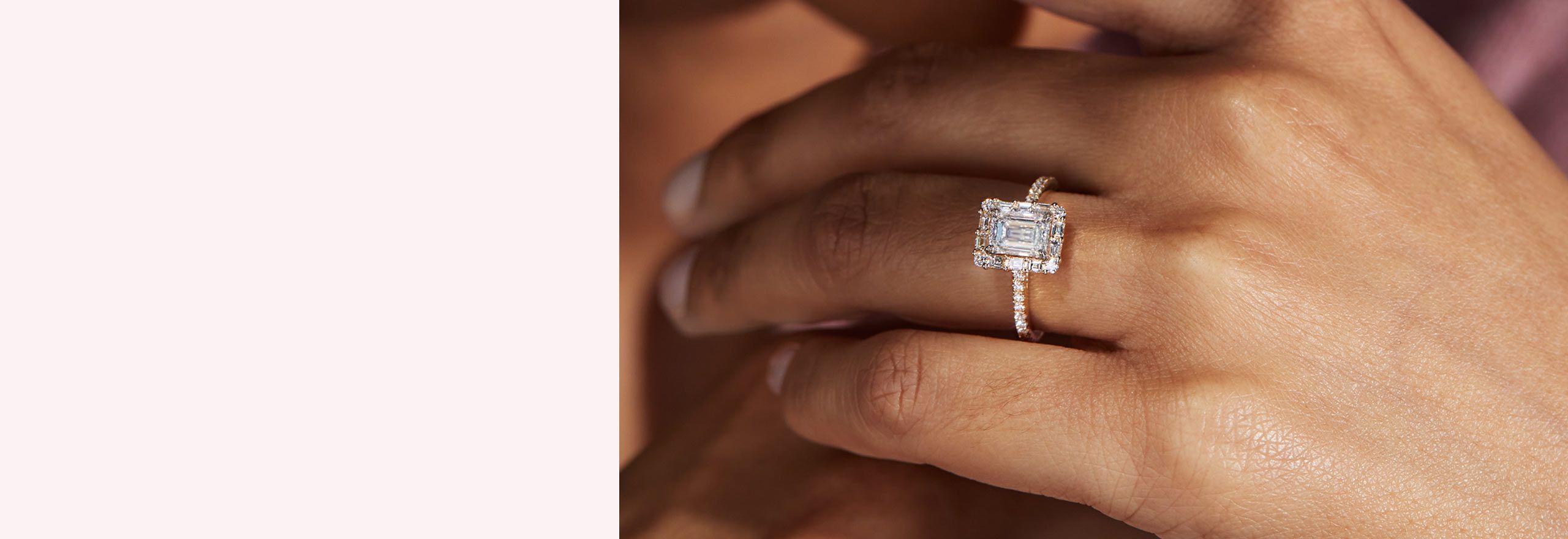 A woman's hand with an emerald cut diamond engagement ring