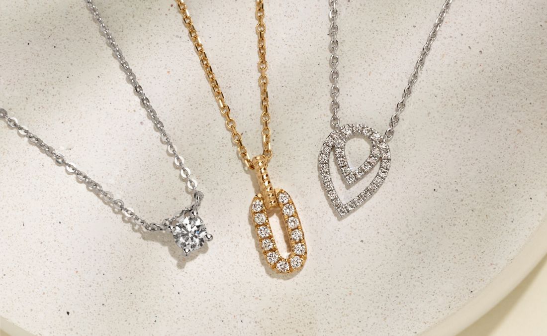 A collection of diamond pendant necklaces