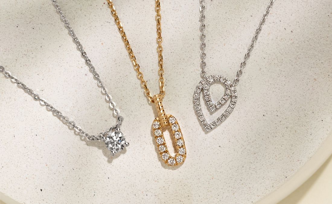 A collection of diamond pendant necklaces
