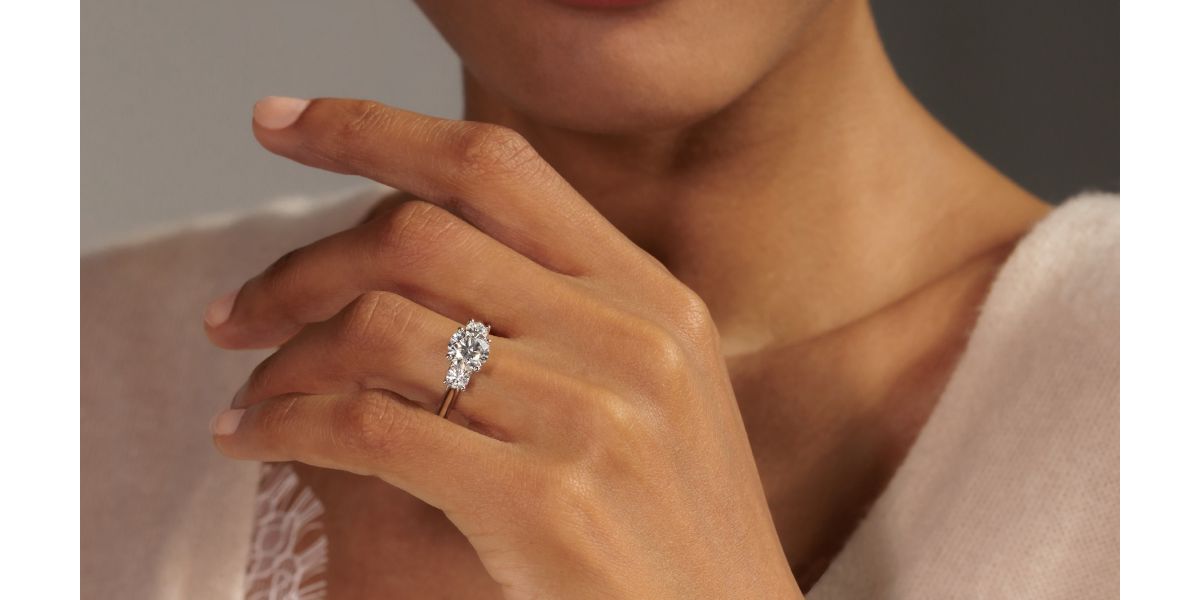 A woman's hand with a natural diamond engagement ring