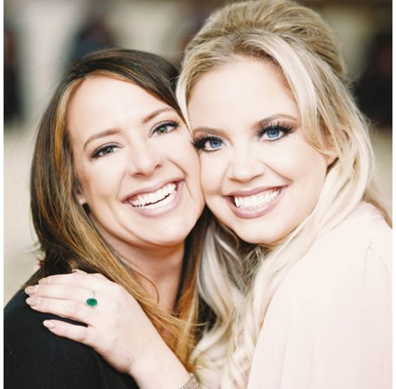 Two women holding each other and smiling