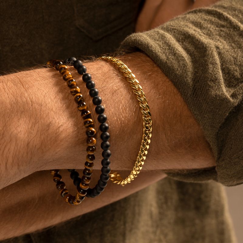 A man wearing multiple bracelets