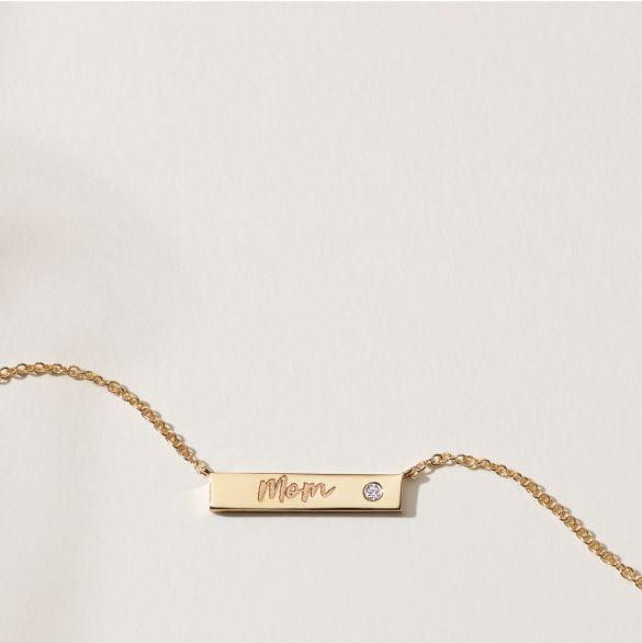 An engraved bar necklace with an inset diamond