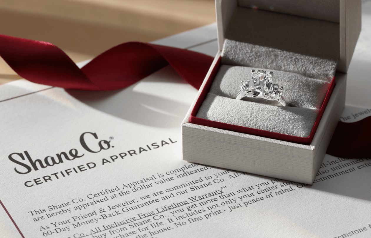 A diamond engagement ring in a Shane Co box with a certified appraisal