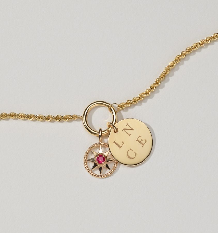 An engraved disc pendant and a gemstone star pendant