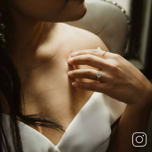 A woman wearing a diamond engagement ring