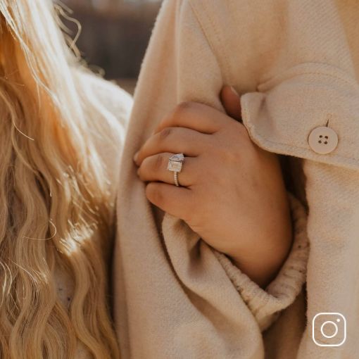 A woman's hand showing off her diamond engagement ring