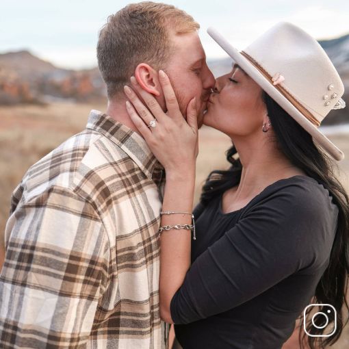 A couple kissing with a picturesque background