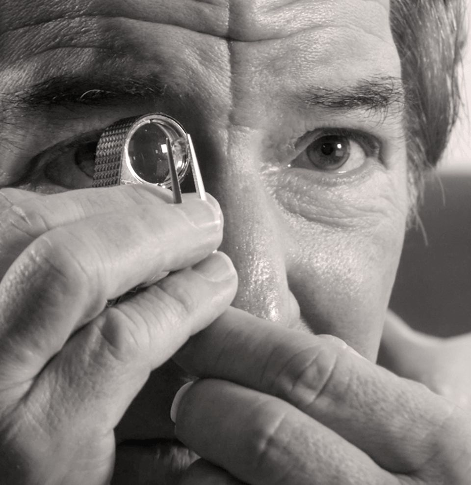 Tom Shane inspecting a loose diamond through a jewelers loupe