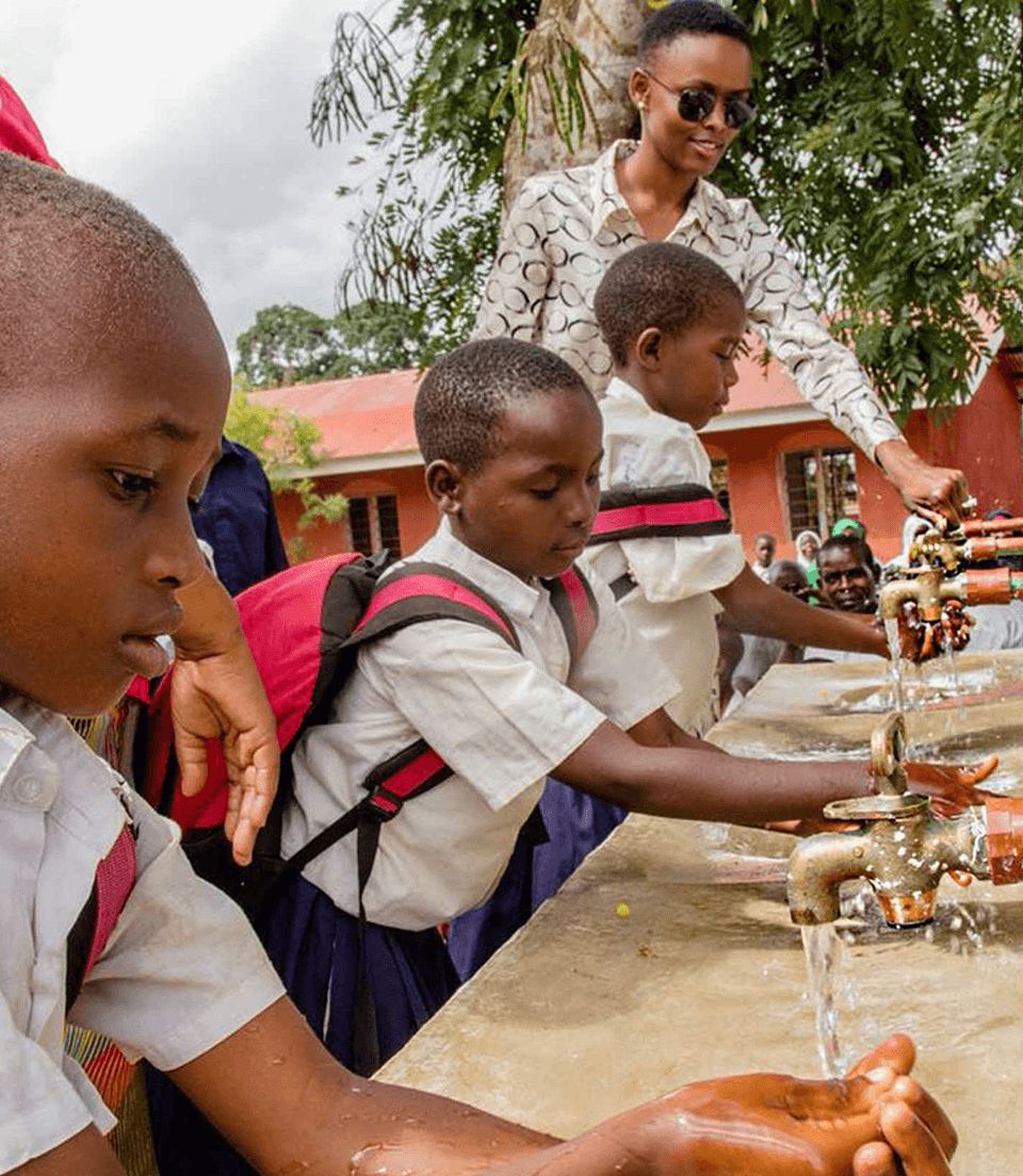 An image of school children washing their hands before going to school