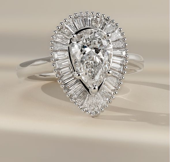 A diamond engagement ring with a pear shaped center diamond