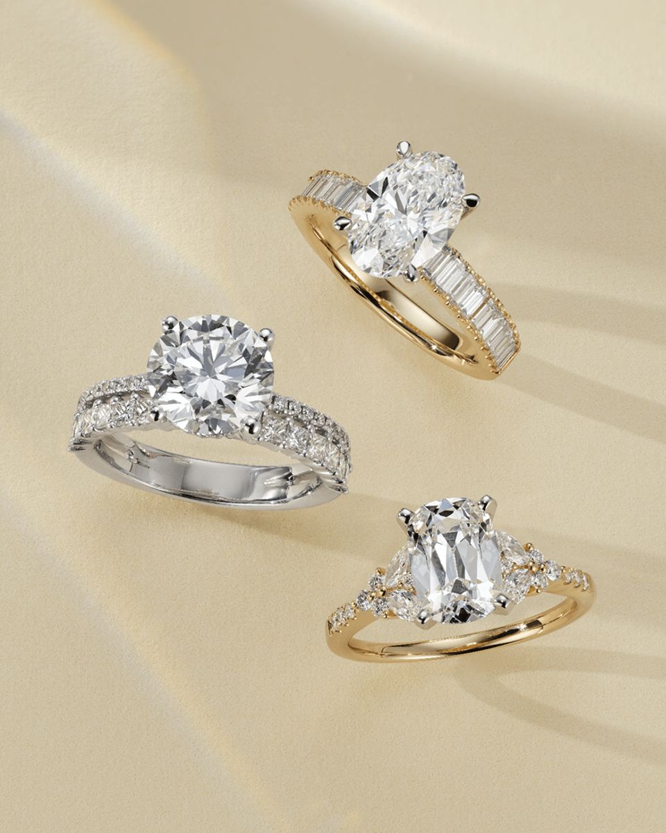 Three diamond engagement rings with different shaped center stone diamonds