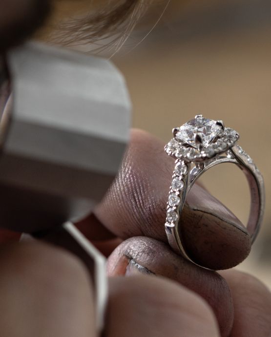 Two diamond engagement rings sitting next to each other