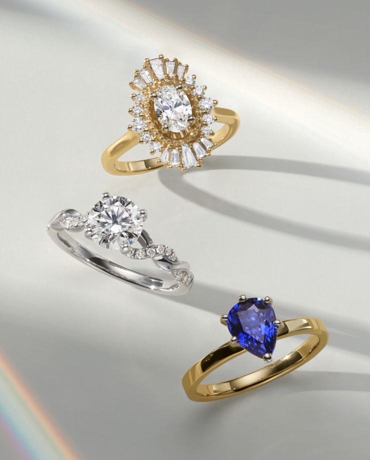A group of three engagement rings with different shaped center stones
