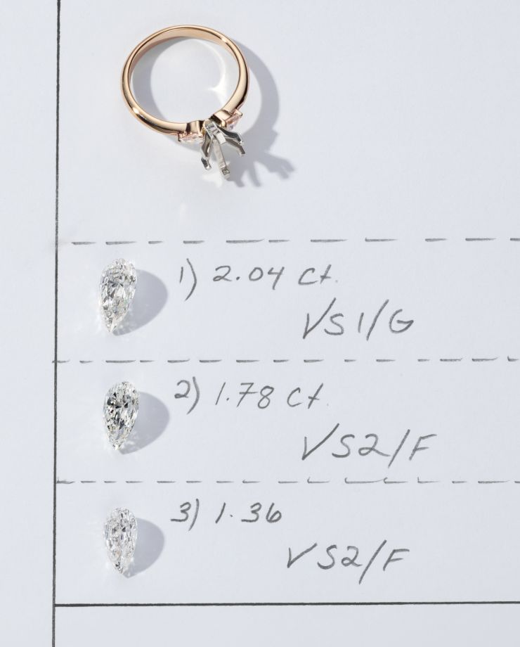 A engagement ring setting above three different grades of diamonds