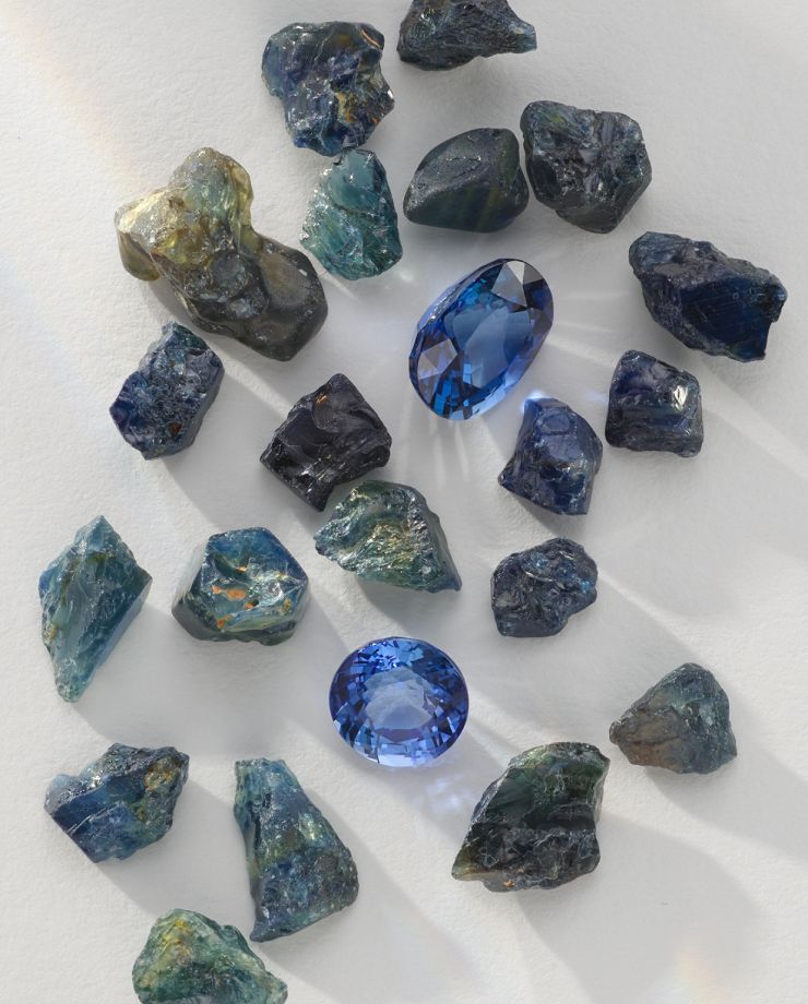 Two cut sapphires surrounded by raw sapphires