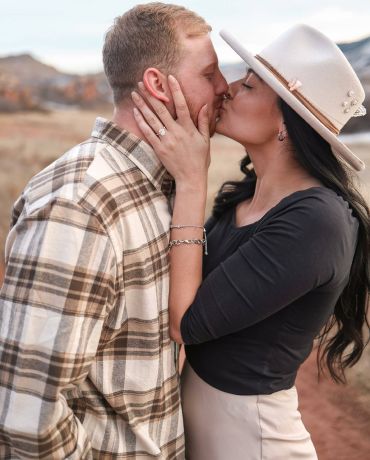 A couple kissing after getting engaged