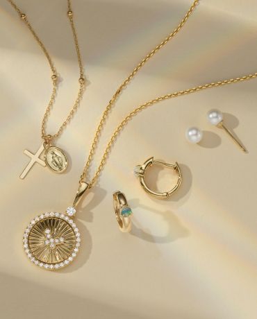 Two fashion necklaces next to two pairs of fashion earrings