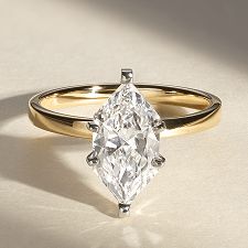 A diamond engagement ring with a marquise center stone
