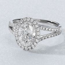A diamond halo engagement ring with an oval center stone